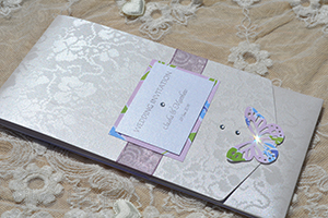 Image of Broderie Butterfly long pocketfold invitation, decorated with organza ribbon, butterfly and gems. 