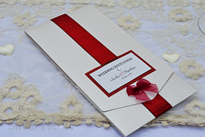 Picture of Ribbons and Bows long pocketfold invitation, decorated with satin ribbon, organza bow and gem. 